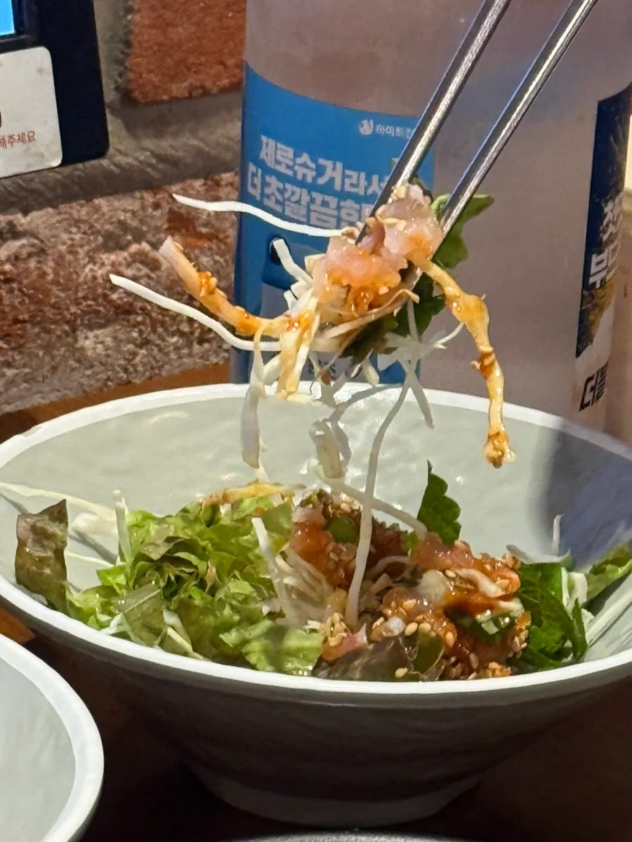 Vinegar-gochujang salad topped with chopped raw fish