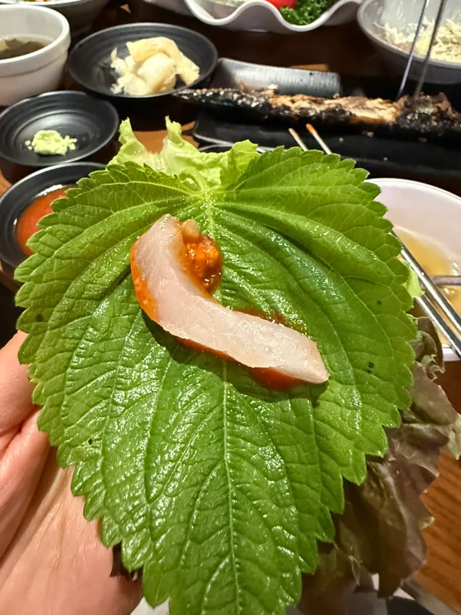 Sashimi wrapped in a perilla leaf