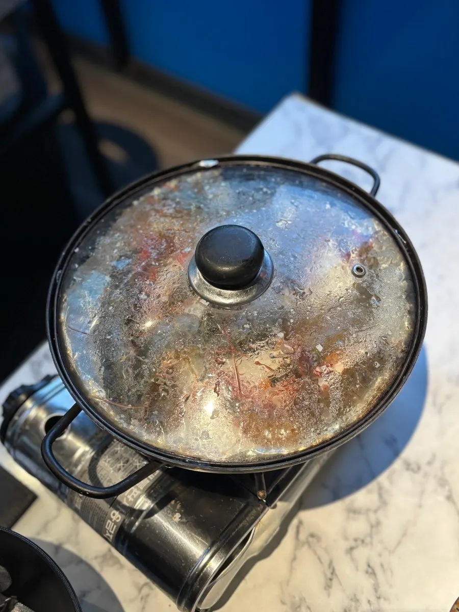 Small order of salt-grilled shrimp cooking on the grill