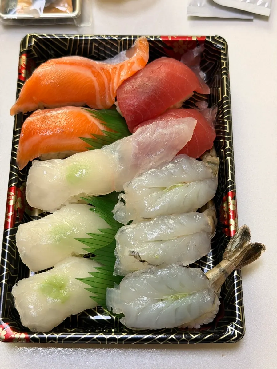 Flounder sushi picked up with chopsticks