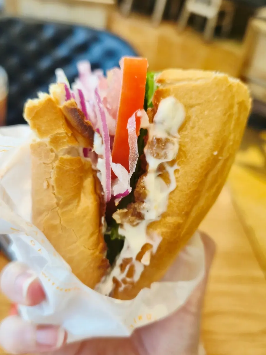 Baguette sandwich pressed down by hand