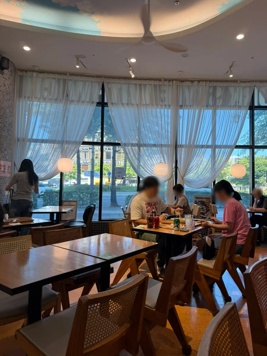 Table seating lit by large windows