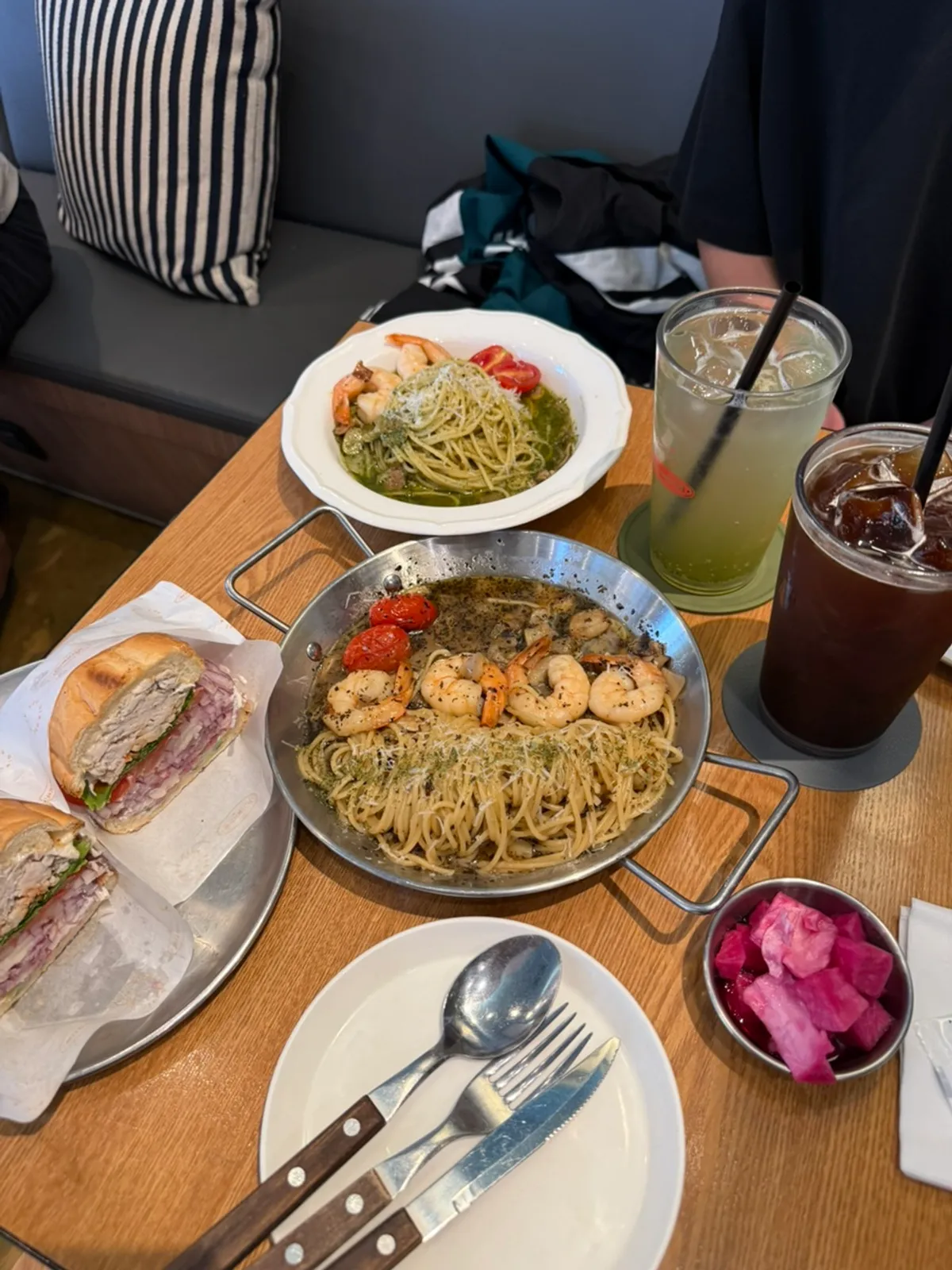 Table set with two pastas and a sandwich