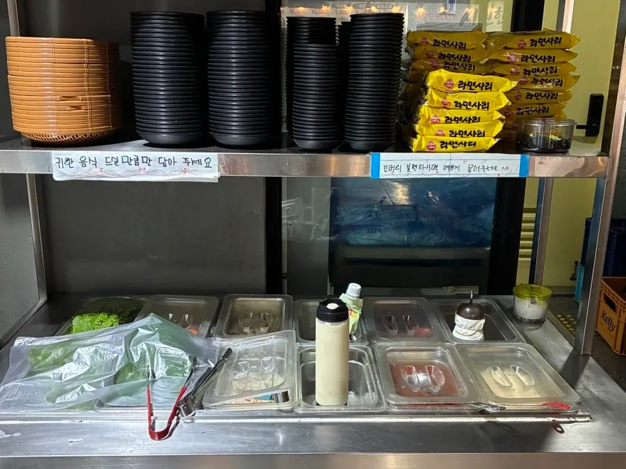Self-serve bar with wrap vegetables, sauces, and ramen noodles