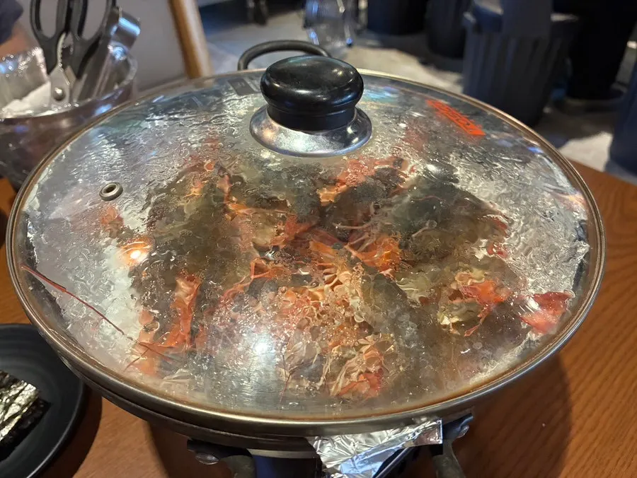 Lid off, shrimp cooking on the grill