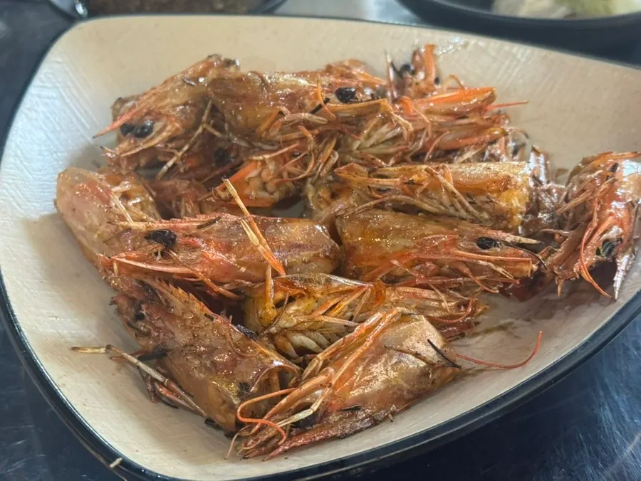 Shrimp salt-grill served alongside a glass of soju