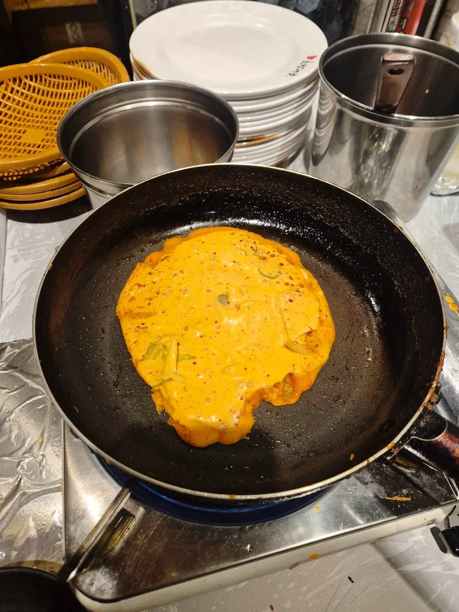 Kimchi pancake cooked at the table