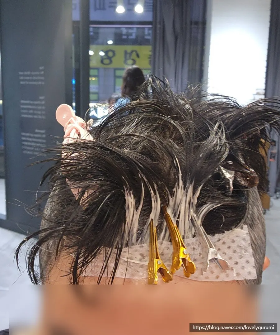 Hair before the service, with sides flared out as the down perm had grown out