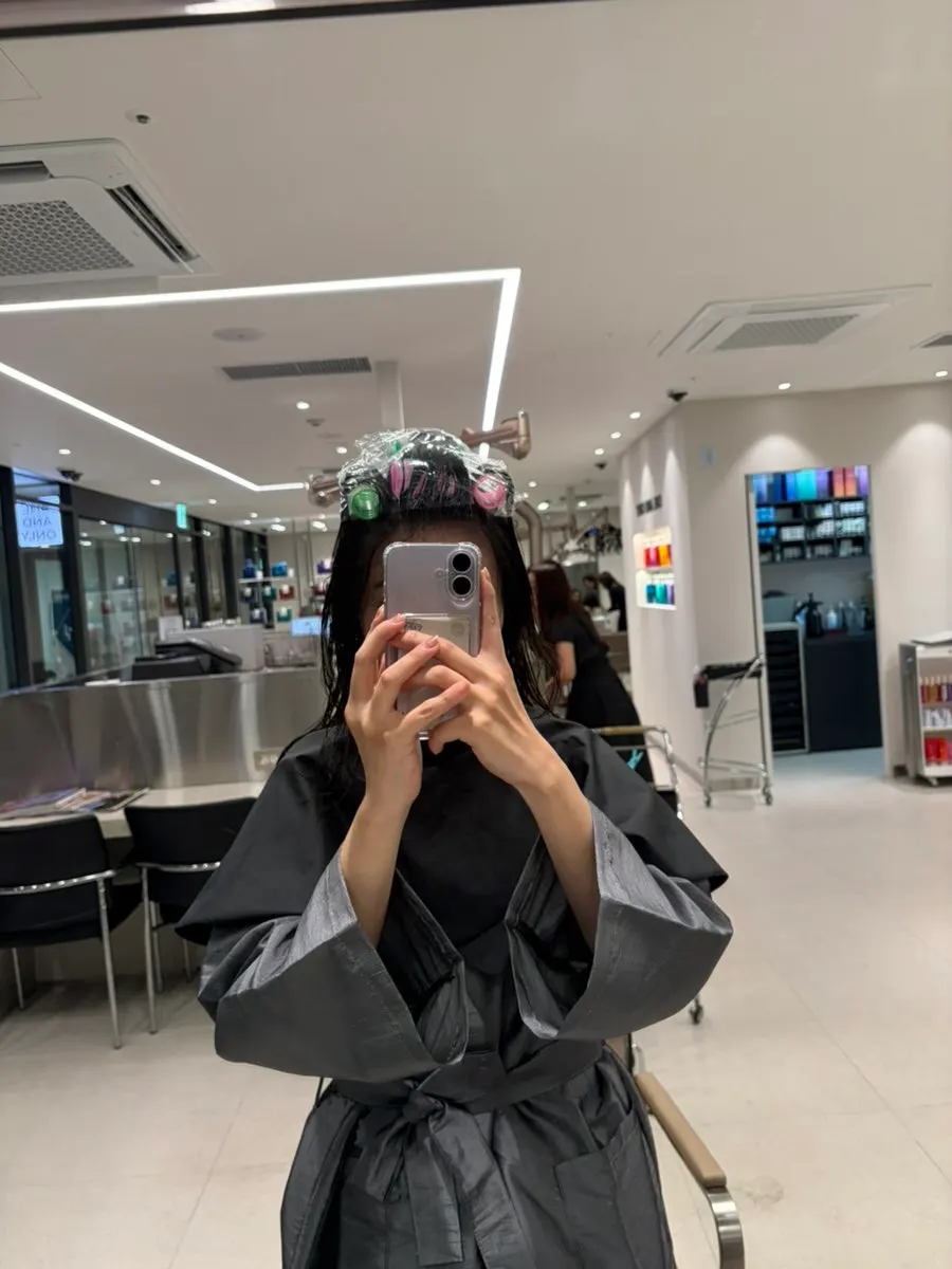 Hair rolled up on rollers for the root volume perm