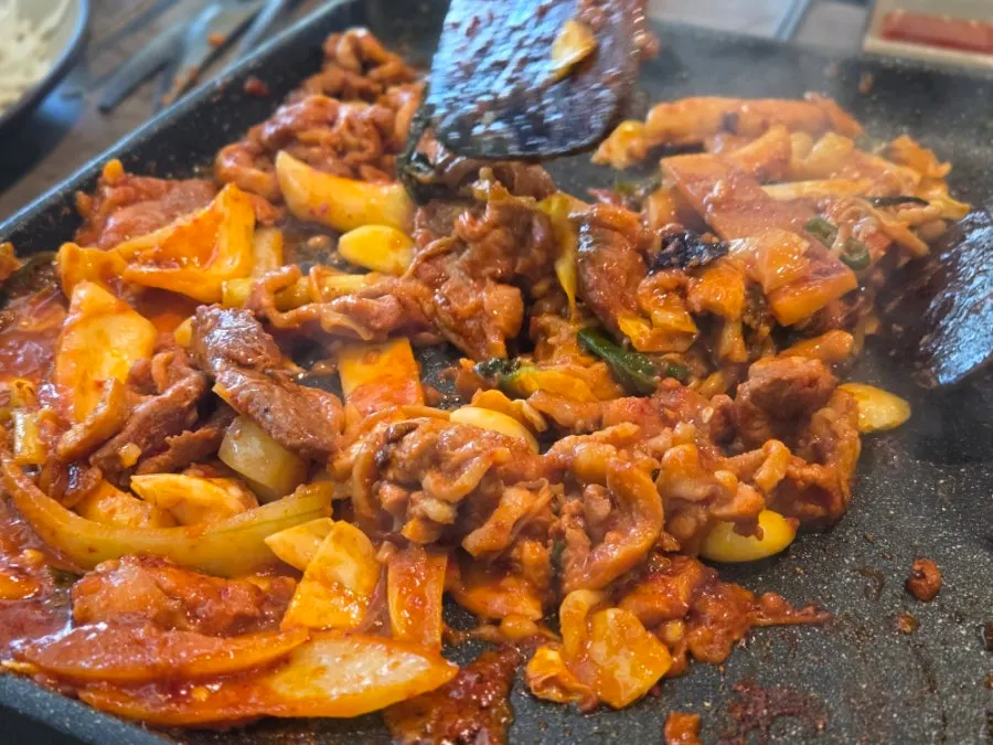 Raw duck spicy stir-fry cooking on the grill
