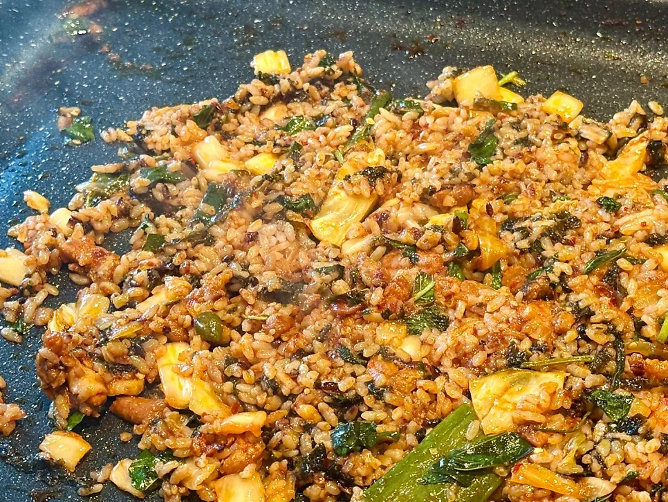 Fried rice being made with leftover sauce and gim flakes