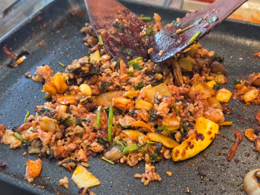Self-fried rice cooking on the grill