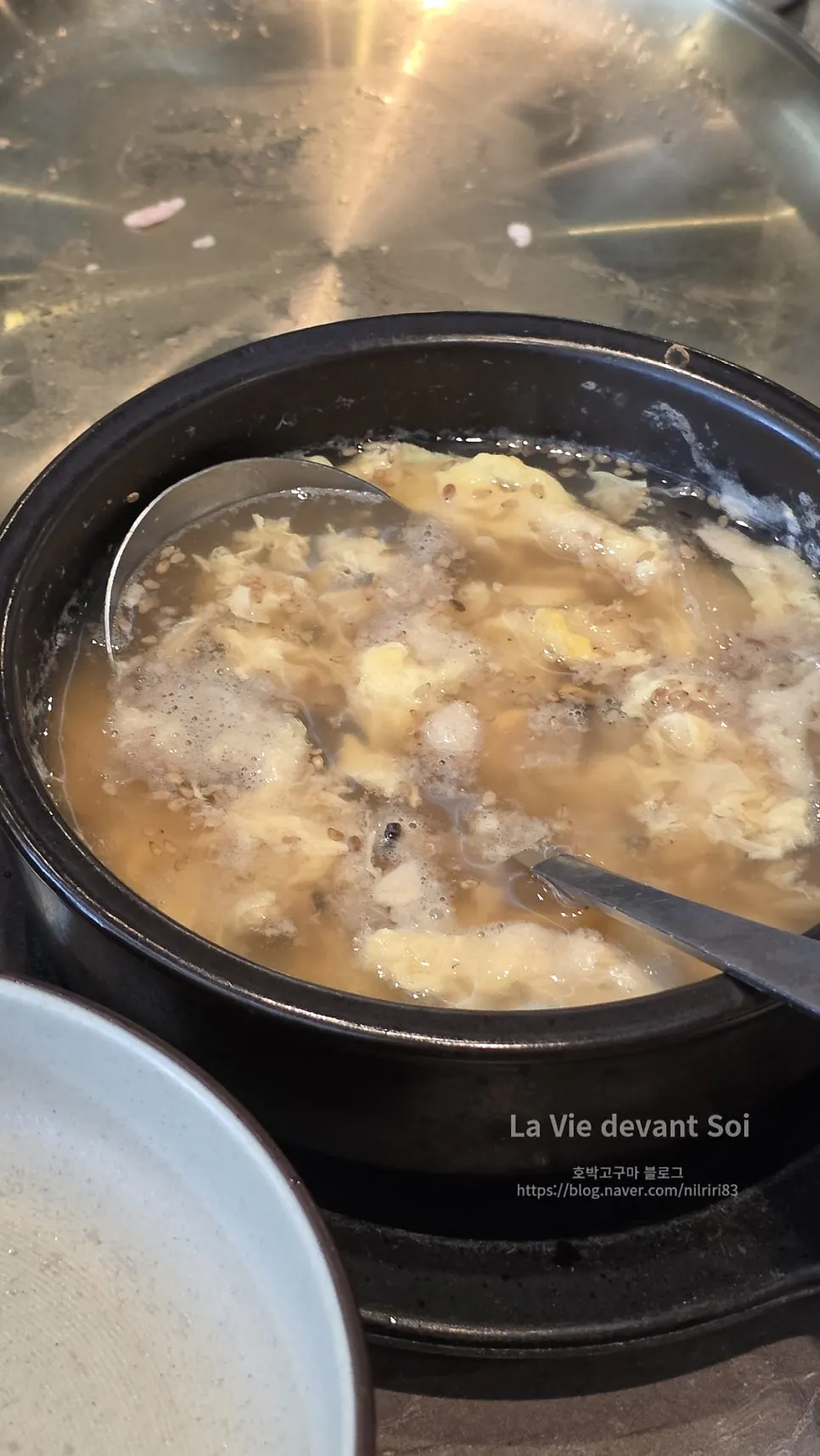 A bowl of egg soup served with rice