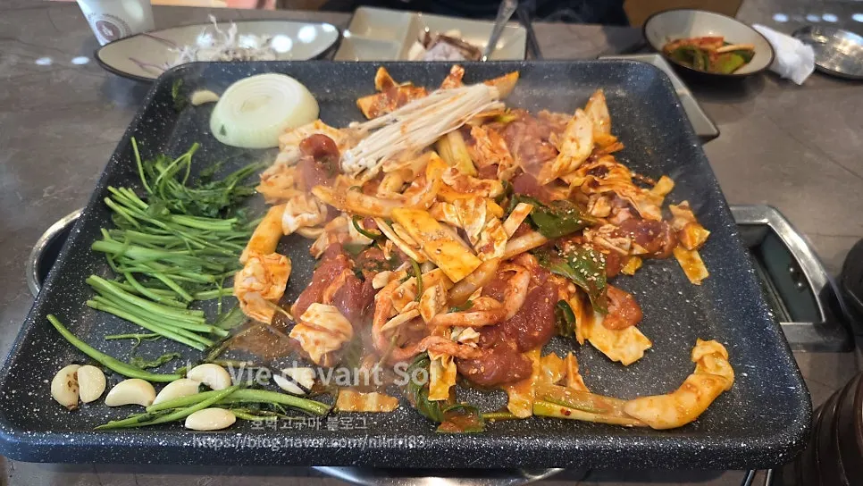 Raw duck stir-fry cooking on the grill