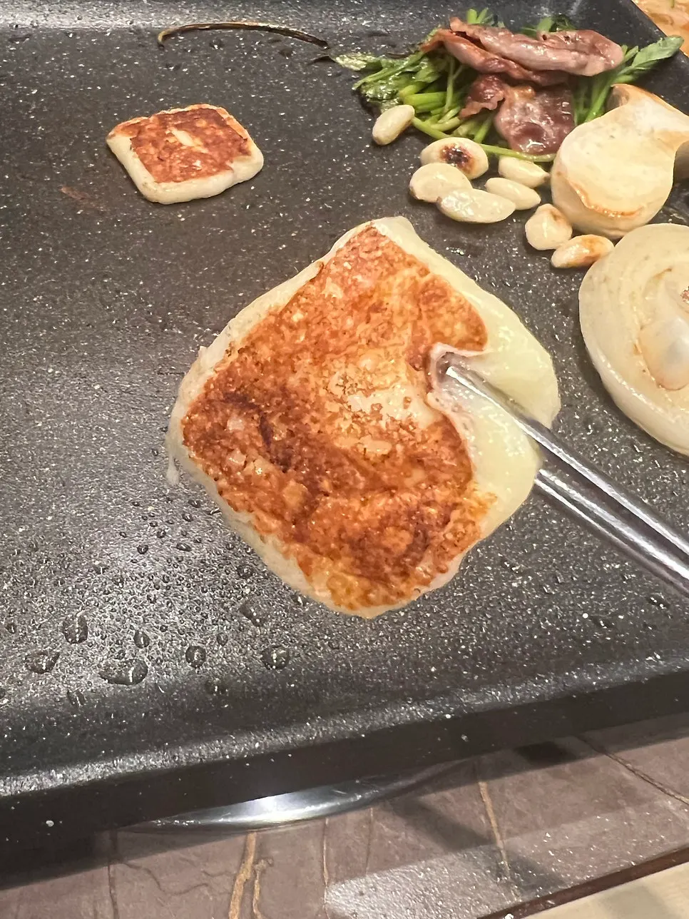 Stretchy cheese piled onto duck brisket