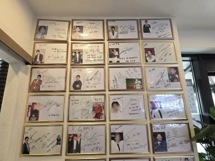Waiting area by the entrance covered in celebrity autographs