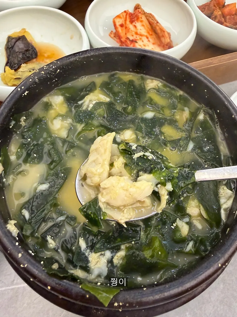 Stone pot of abalone flounder seaweed soup with whole abalone and flounder