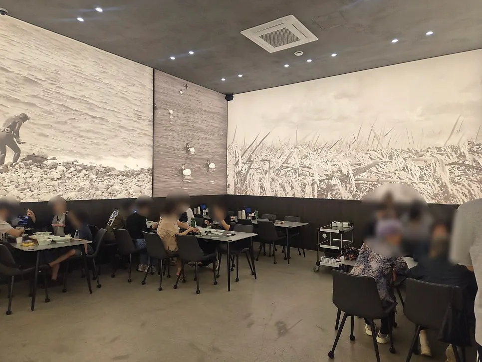 Dining hall seats at Haenon Miyeok right after opening, with a guest seated