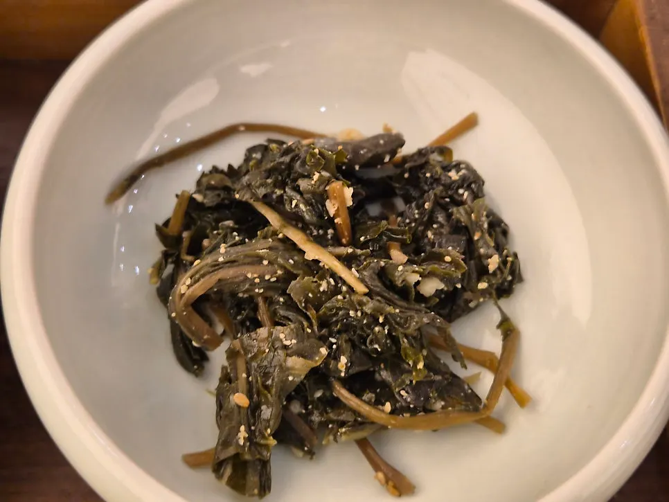 Fried eggplant and seasoned greens among the side dishes
