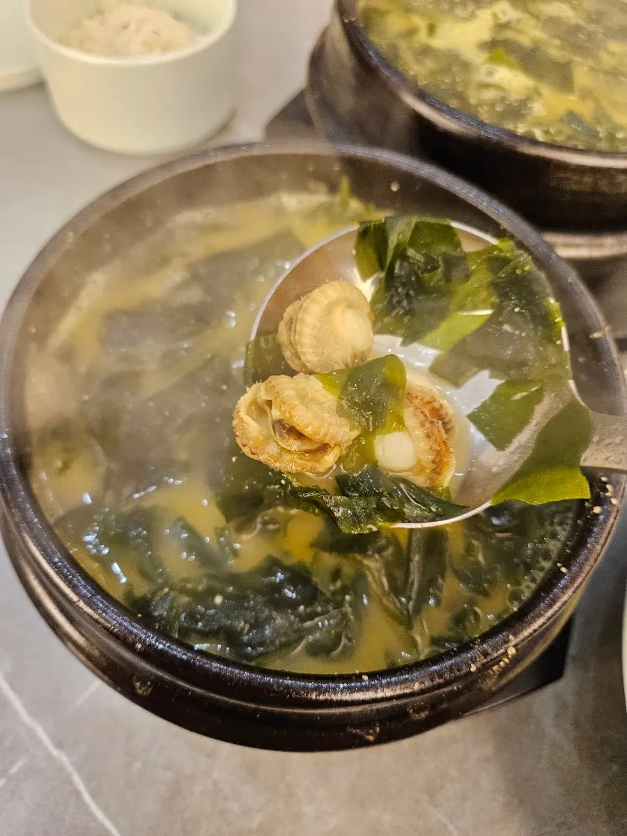 Bubbling hot seaweed soup pots on the table