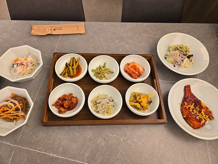 Side dishes including japchae and salad
