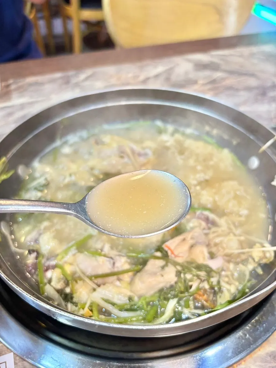 A spoonful of the richly steeped haesintang broth