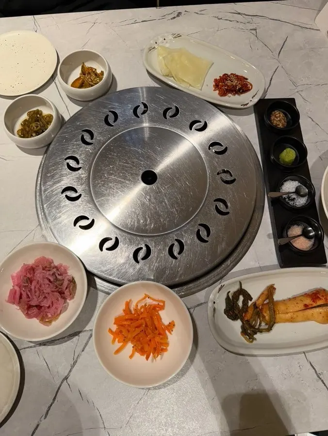 Table setting of house-made namul and kimchi side dishes