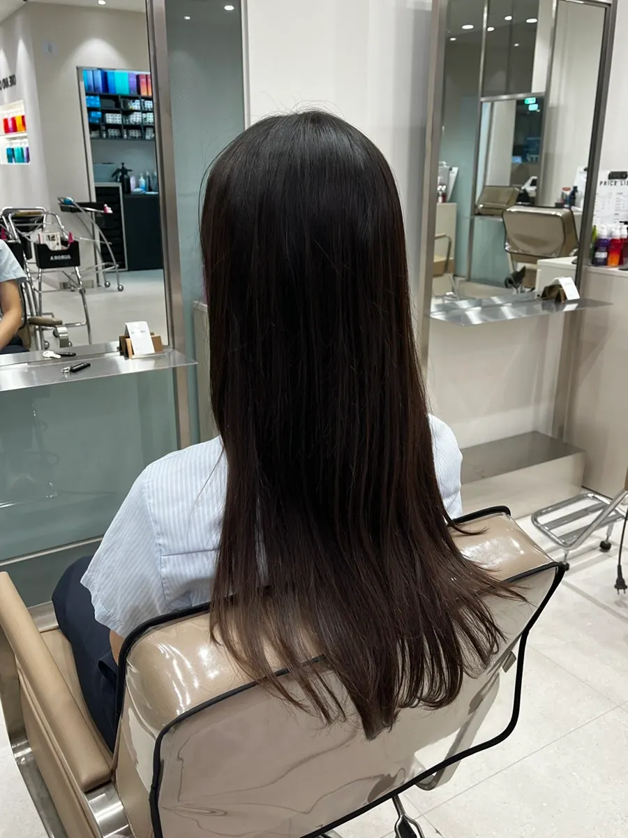 Seated in the salon chair, preparing for the cut