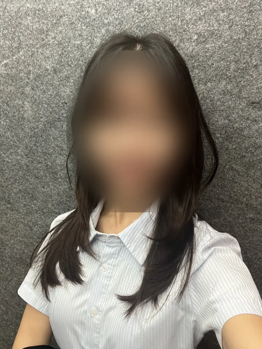 Full-length view of the finished layered cut in the mirror