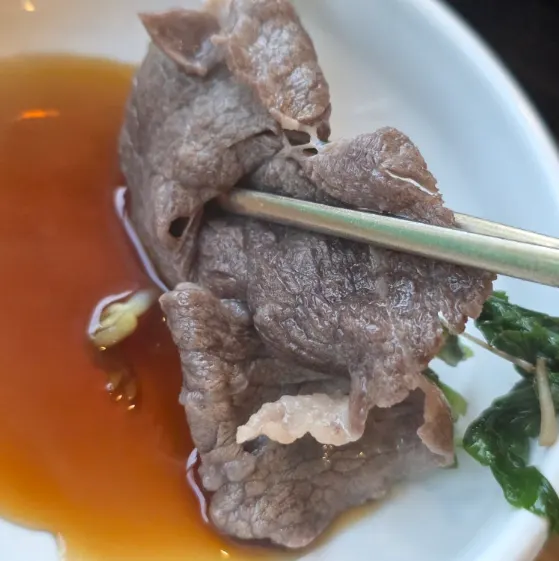 Meat and minari dipped in soy sauce