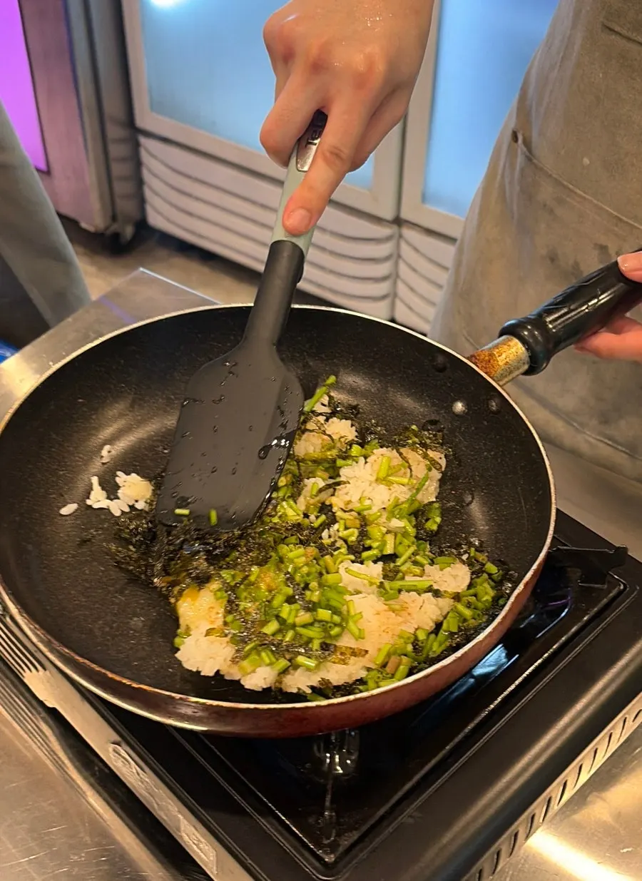 Fried rice ingredients with rice, egg, seaweed flakes, and minari