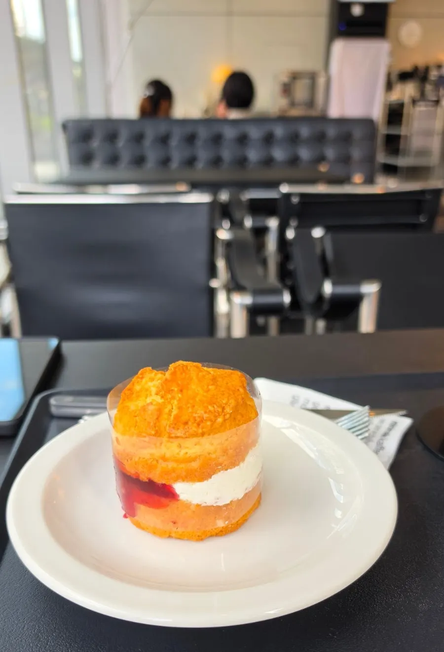 Victoria scone plated with cream and strawberry jam