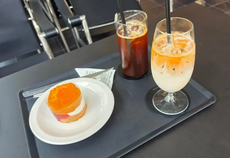 Table with drinks and scone about to be eaten