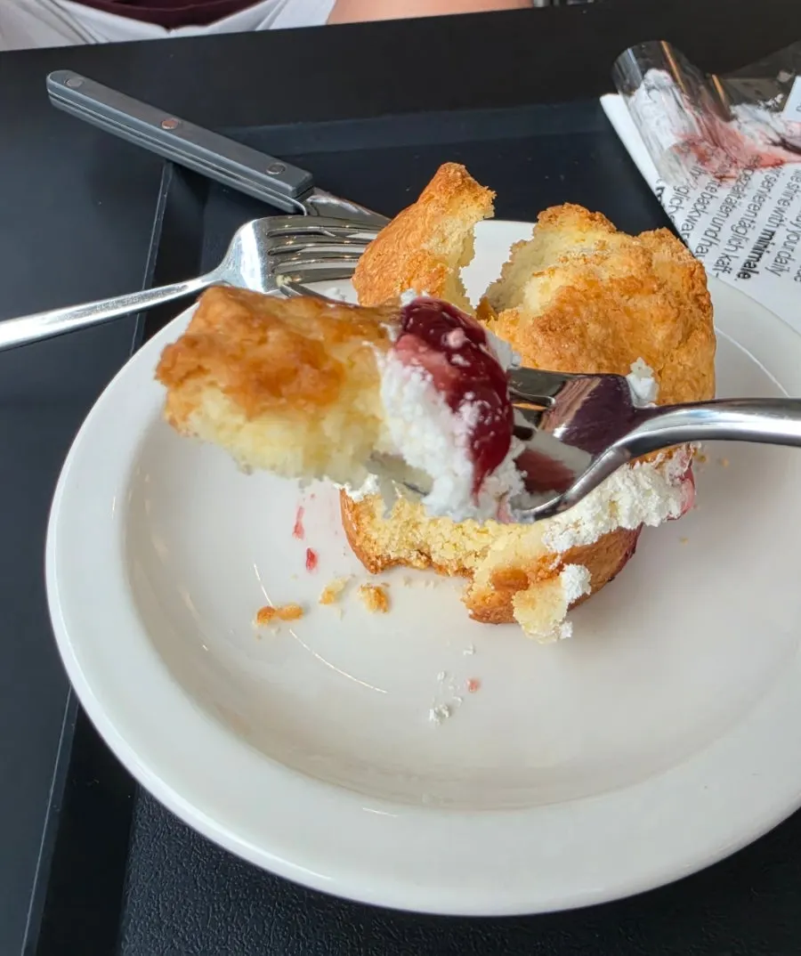 Nearly finished scone plate alongside coffee
