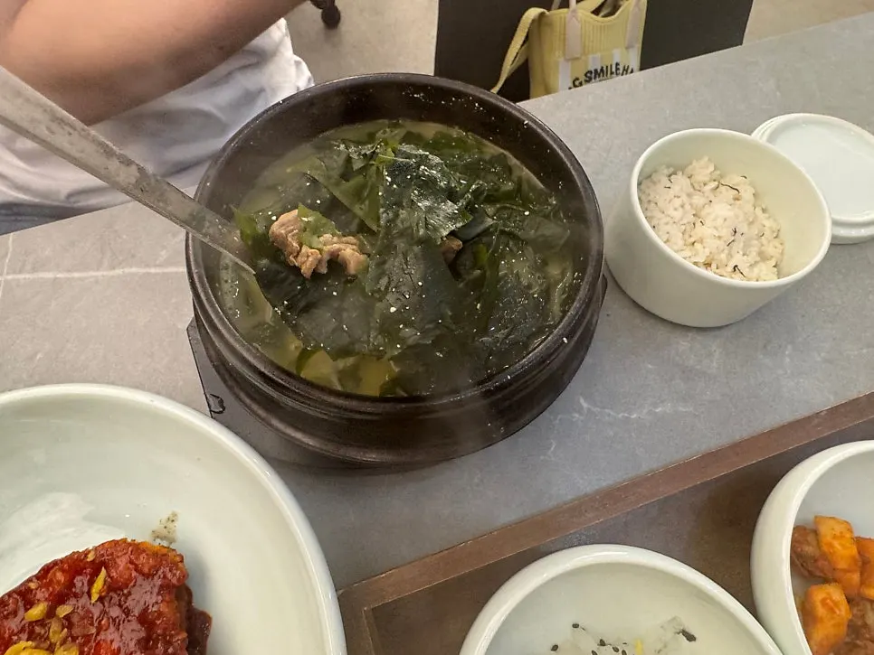 Spoonful of seaweed soup with beef lifted out