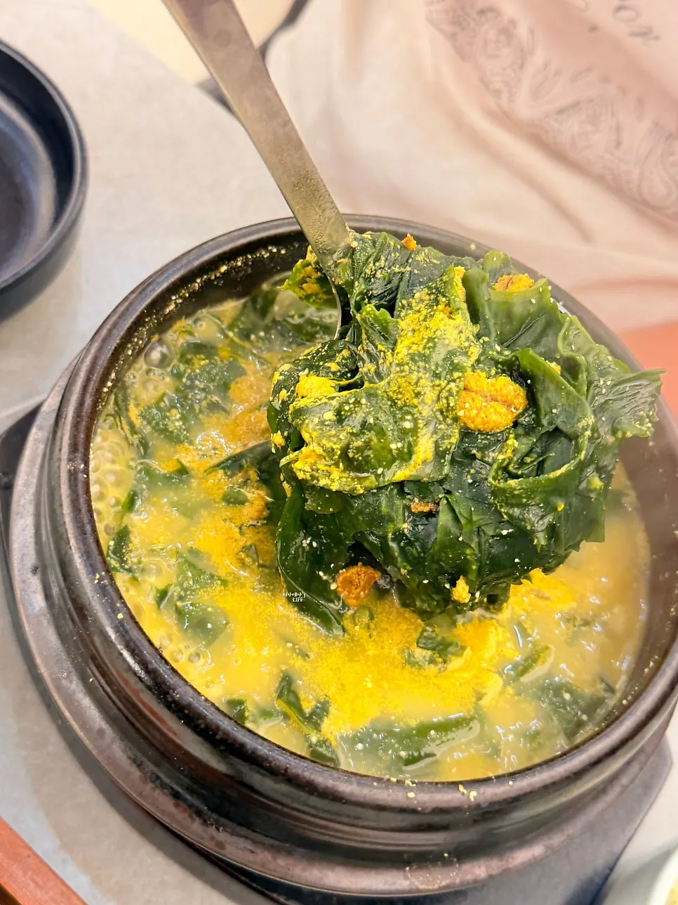 Milky white broth of the sea urchin roe seaweed soup