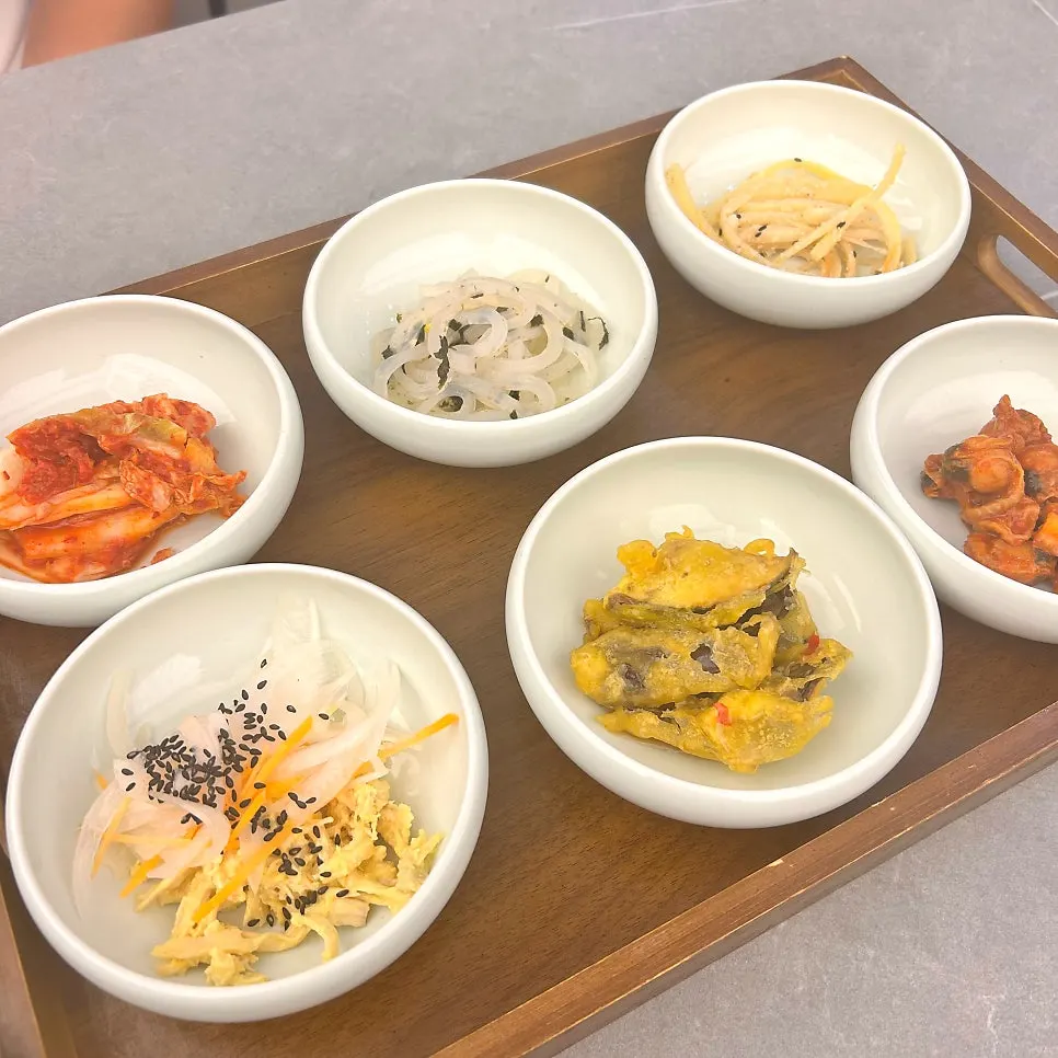 Table spread of six banchan served with the set meal