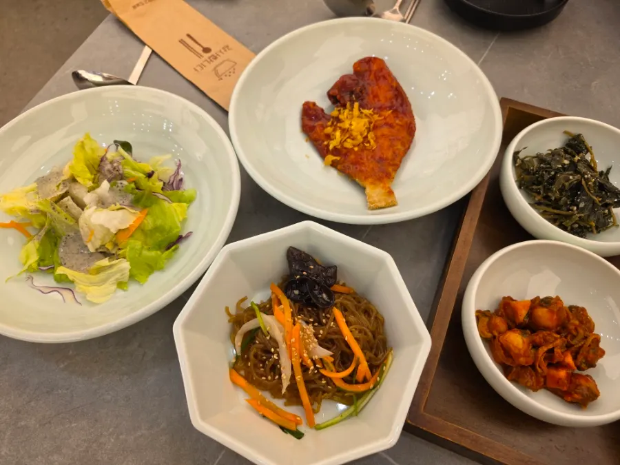 Full spread of side dishes including grilled flounder