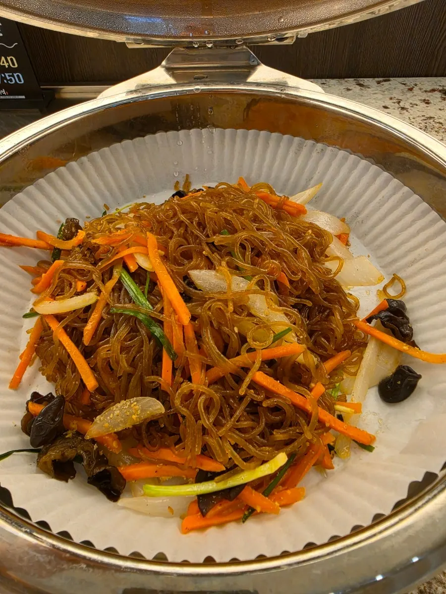A bowl of side dishes taken from the self-serve bar