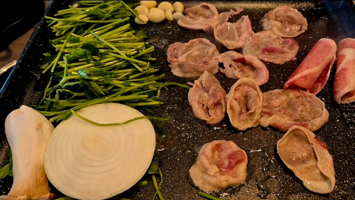 Duck chadol and minari grilling on the hot plate