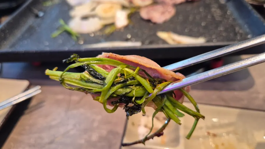 A piece of duck chadol dipped in sauce