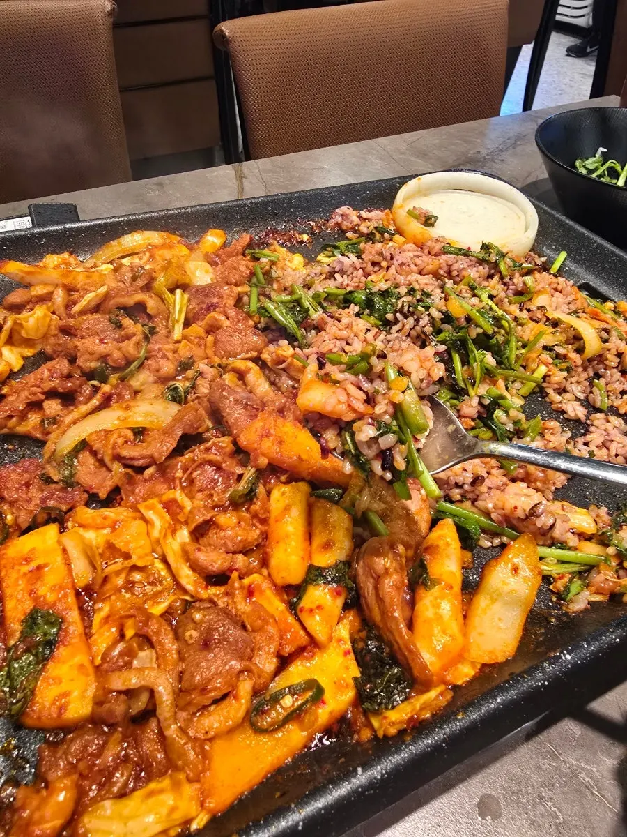 A piece of duck jumuljeok placed on wrap vegetables