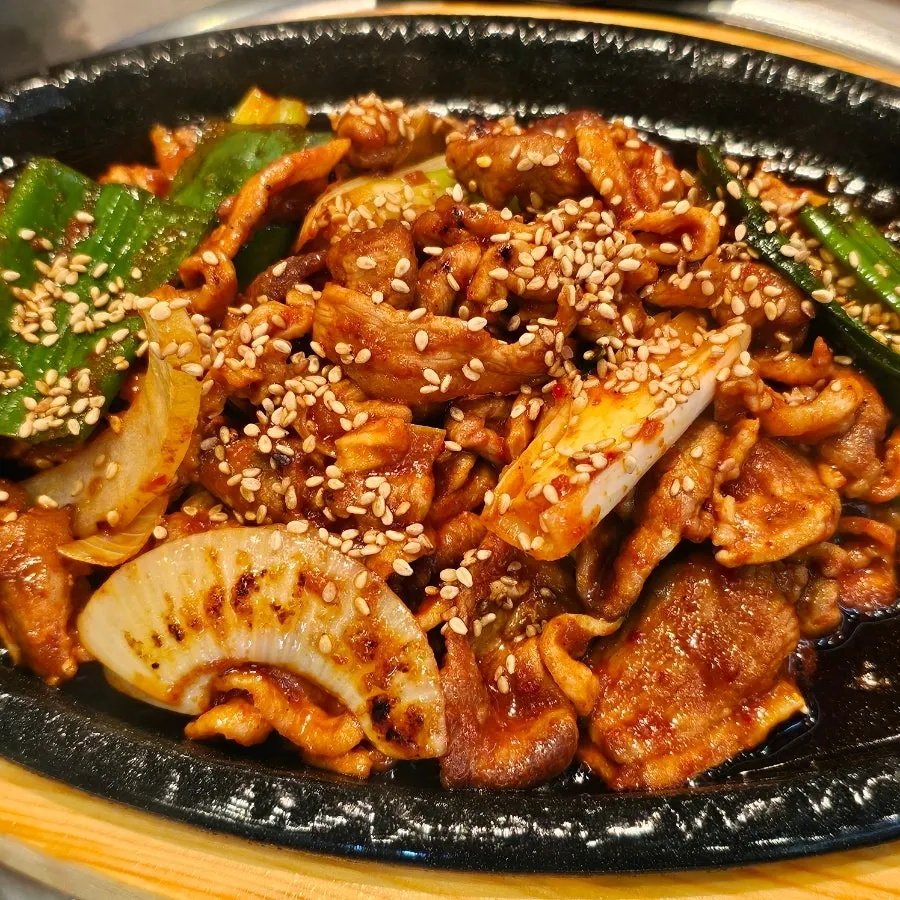 Duck jeyuk grilling on the hot plate