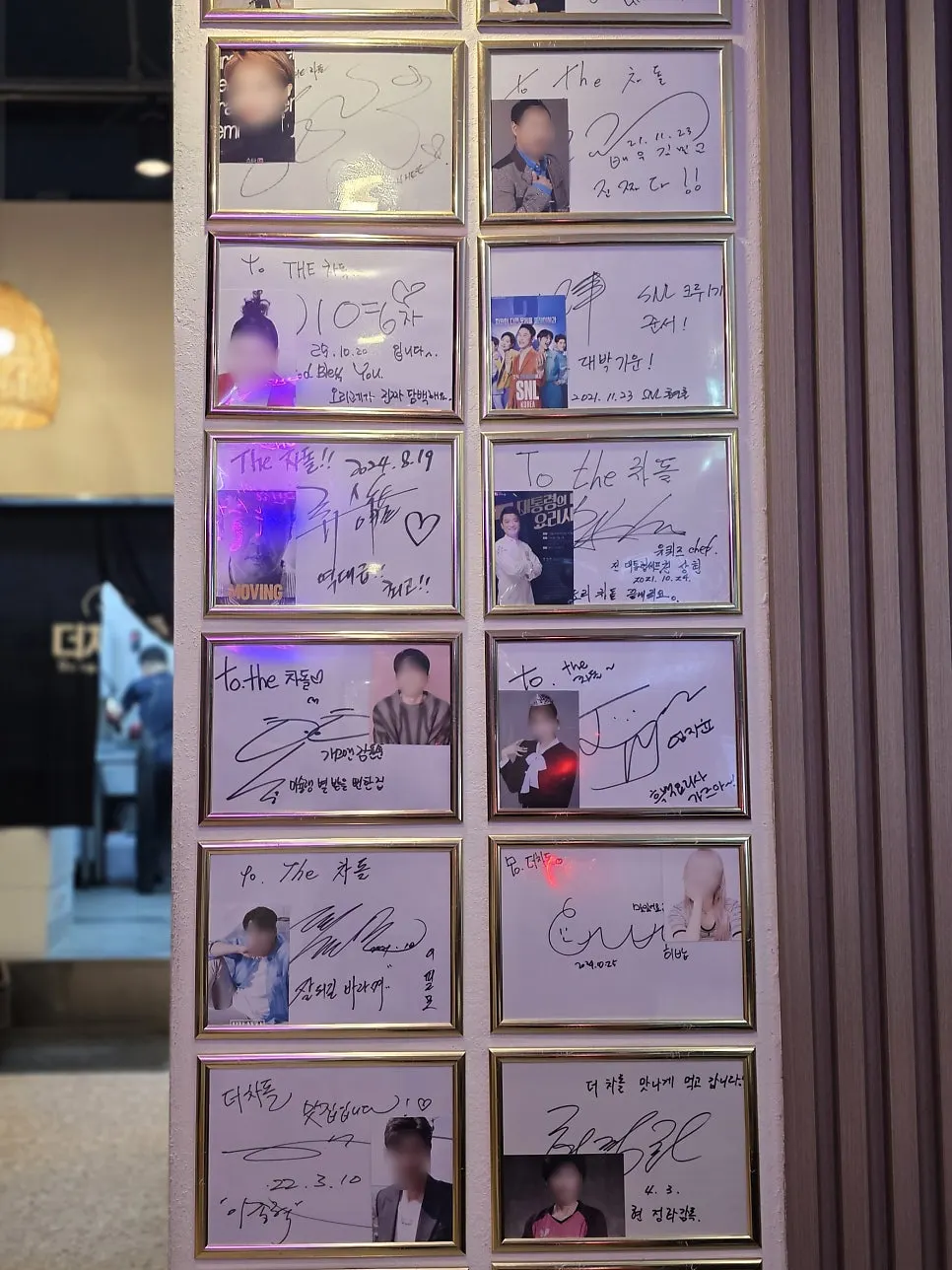 Wall covered in celebrity autographs at Deo Chadol
