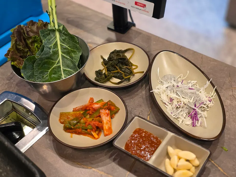 Basic table setting with lettuce wraps and kimchi at Deo Chadol