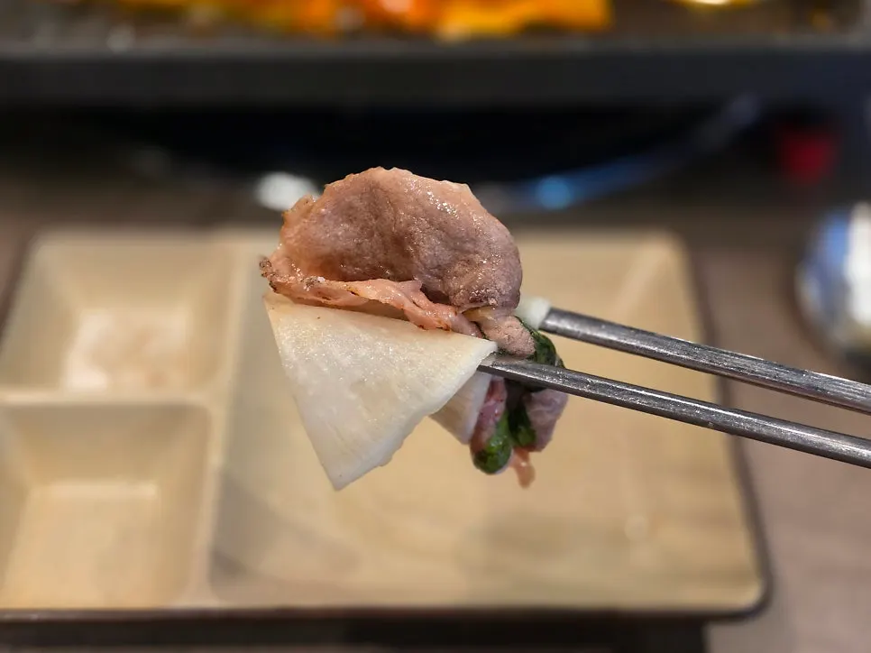 A piece of duck chadol dipped in special sauce