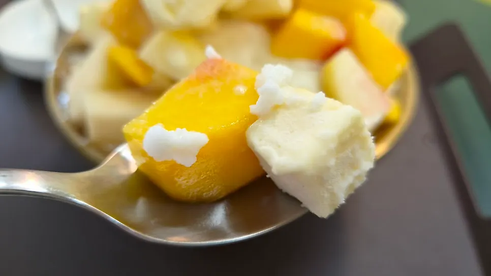 Cross-section of a spoonful of peach bingsu