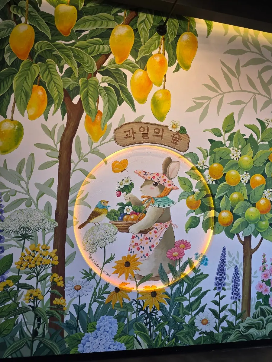 Fruit Forest photo zone painted with fruit trees and a rabbit