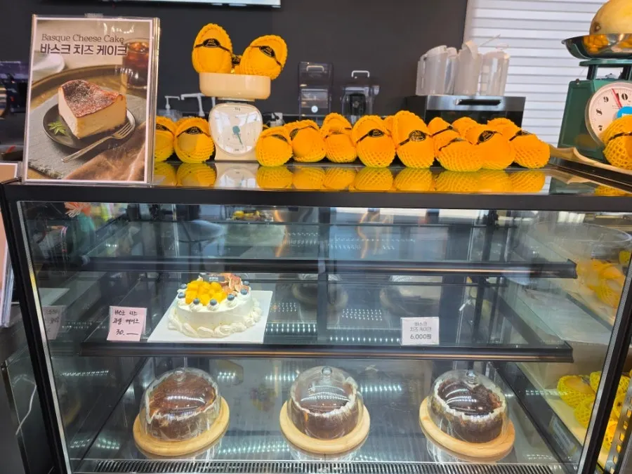 Counter display with cakes and mangoes on show