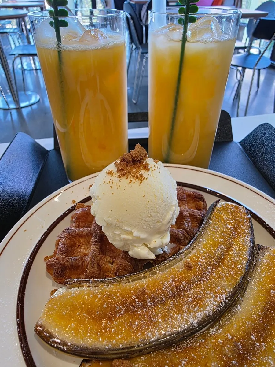A cold glass of fresh mango juice over ice
